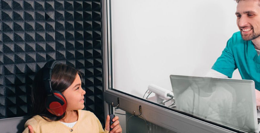 audiometry test. Audiologist doing hearing test to a little girl, checking child hearing